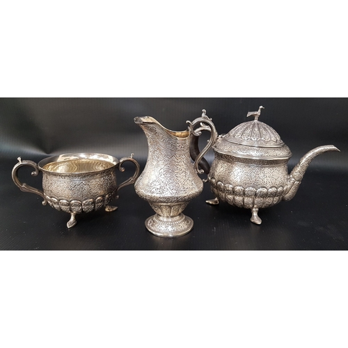 220 - INDIAN SILVER TEA SET
comprising a tea pot, milk jug and twin handled sugar bowl, all with profuse e... 