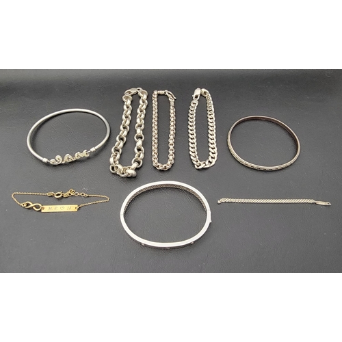 184 - SELECTION OF SILVER BRACELETS 
including bangles, chains and an engraved identity bracelet