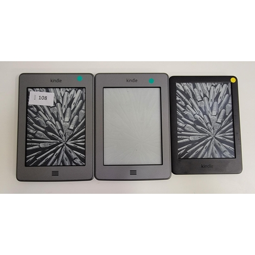 108 - THREE AMAZON KINDLE E-READERS
comprising Kindle Touch Wifi, serial number B011 1608 2325 02NM; Kindl... 