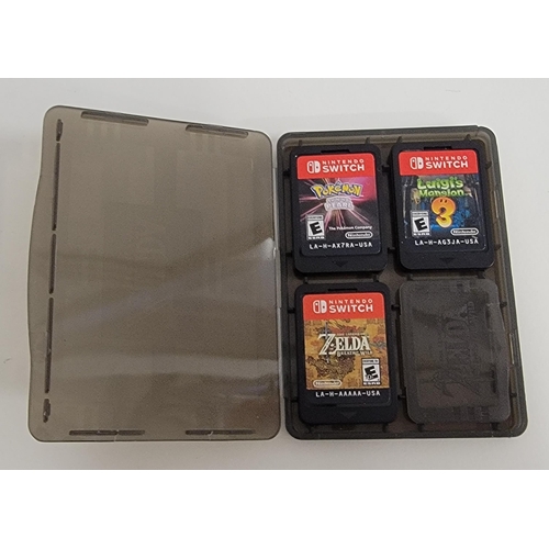 236 - THREE NINTENDO SWITCH GAMES 
in The Legend of Zelda Breath of Wind protective case, comprising The L... 