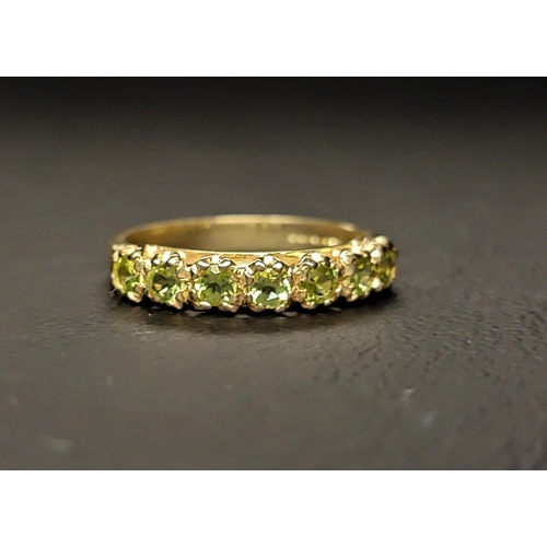 131 - PERIDOT HALF ETERNITY RING 
the seven round cut peridots totalling approximately 0.50cts on a nine c... 