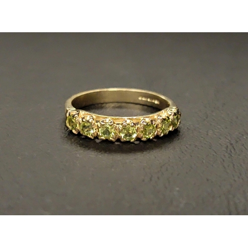 131 - PERIDOT HALF ETERNITY RING 
the seven round cut peridots totalling approximately 0.50cts on a nine c... 