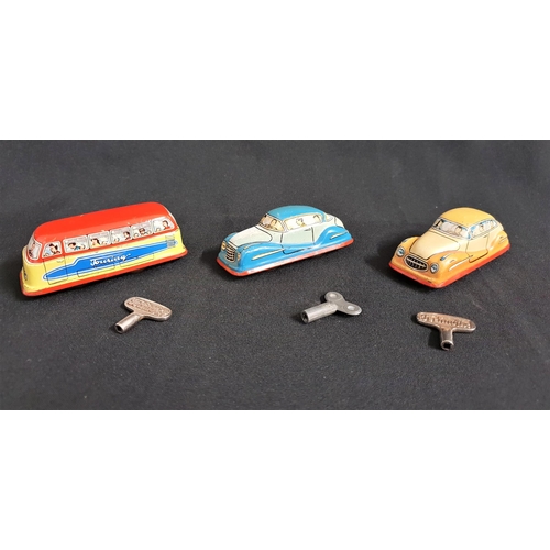 361 - THREE WEST GERMAN TIN PLATE VEHICLES
comprising two family cars and a Touring bus, all with keys