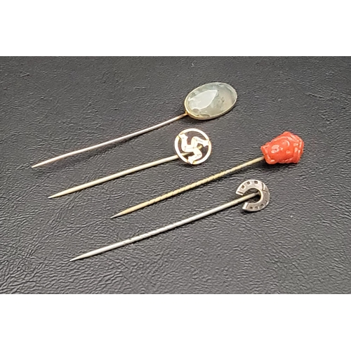 14 - FOUR VARIOUS STICK PINS
comprising a moss agate set ten carat gold example; a nine carat gold pin de... 