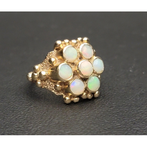17 - IMPRESSIVE OPAL CLUSTER RING
the seven round cabochon opals in moulded setting with ball detail, in ... 