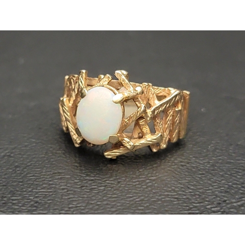 112 - OPAL SINGLE STONE RING
the oval cabochon opal flanked by abstract textured rod detail, in nine carat... 