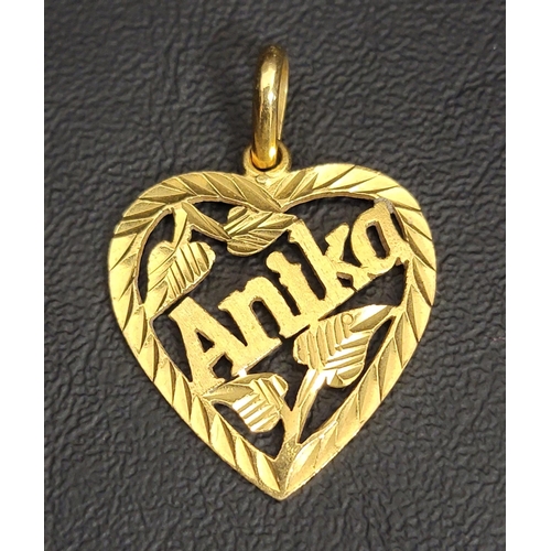 116 - TWENTY-TWO CARAT GOLD HEART-SHAPED PENDANT
with punctured foliage motifs and 'Anika' through the cen... 