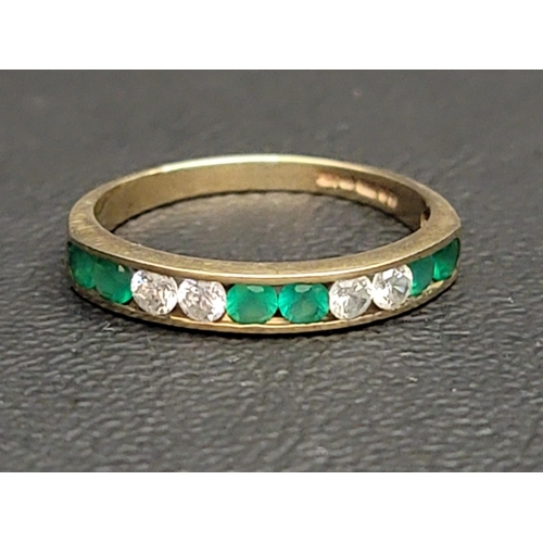 128 - GREEN AND CLEAR STONE SET HALF ETERNITY RING
in nine carat gold, ring size N-O