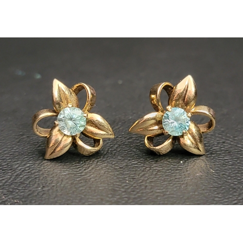 95 - PAIR OF BLUE TOPAZ FLOWER DESIGN EARRINGS
in nine carat gold, the central blue topaz on each with pe... 