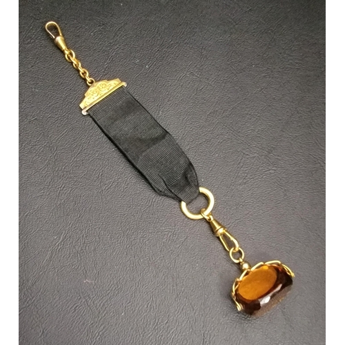 105 - CAIRNGORM SWIVEL FOB
in nine carat gold mount, on black ribbon Albertina with gold plated mounts