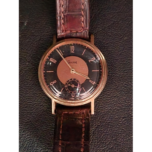 165 - UNUSUAL GENTLEMEN'S GAMA FOURTEEN CARAT GOLD CASED WRISTWATCH
the black and bronze coloured dial wit... 