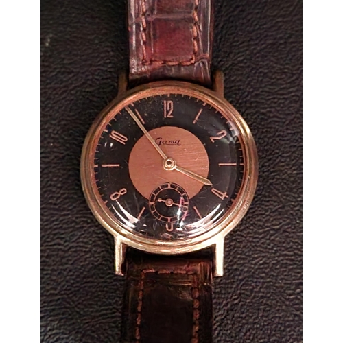 165 - UNUSUAL GENTLEMEN'S GAMA FOURTEEN CARAT GOLD CASED WRISTWATCH
the black and bronze coloured dial wit... 