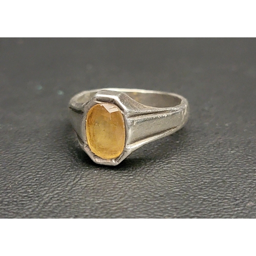 166 - HEAVY UNMARKED SILVER SIGNET STYLE RING
the flush set yellow stone, possibly yellow sapphire, approx... 