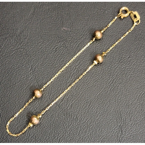 2 - EIGHTEEN CARAT GOLD BRACELET 
with four interspersed beads, approximately 2.7 grams