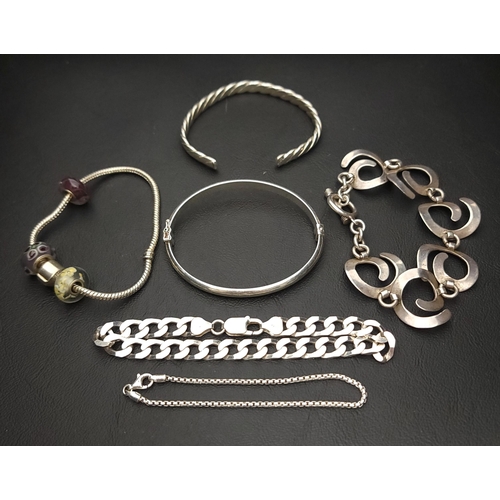 31 - SELECTION OF SILVER BRACELETS 
including chain bracelets, one with spiral links, a Pandora style bra... 
