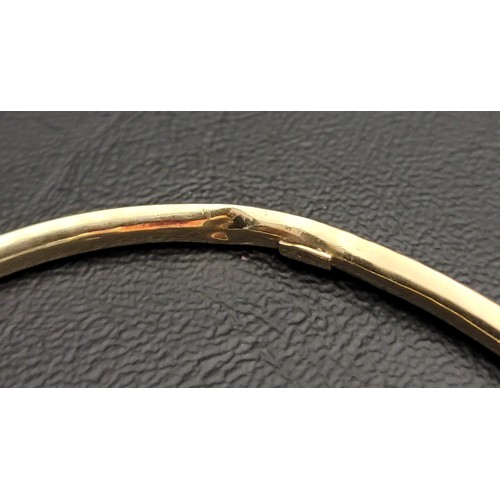 202 - NINE CARAT GOLD BANGLE 
with a diagonal hatched design, approximately 5.4 grams