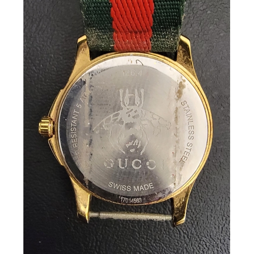 183 - GUCCI EMBROIDERED BEE WRISTWATCH 
the red and green fabric dial embroidered with a gold bee, on a re... 