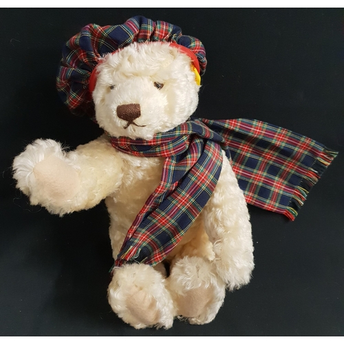 375 - STEIFF MOHAIR GROWLER TEDDY BEAR
with a tartan hat and scarf, jointed limbs and ear stud, numbered 6... 