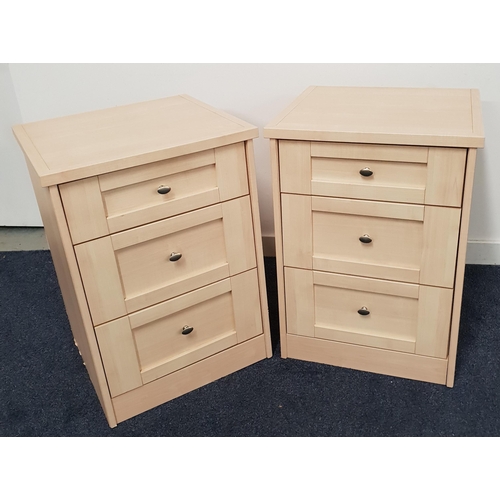 496 - PAIR OF LIGHT OAK BEDSIDE CHESTS
with square tops above panelled drawers, standing on a plinth base,... 