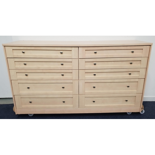 497 - LARGE LIGHT OAK CHEST OF DRAWERS
with an arrangement of ten drawers, standing on a plinth base, 100c... 