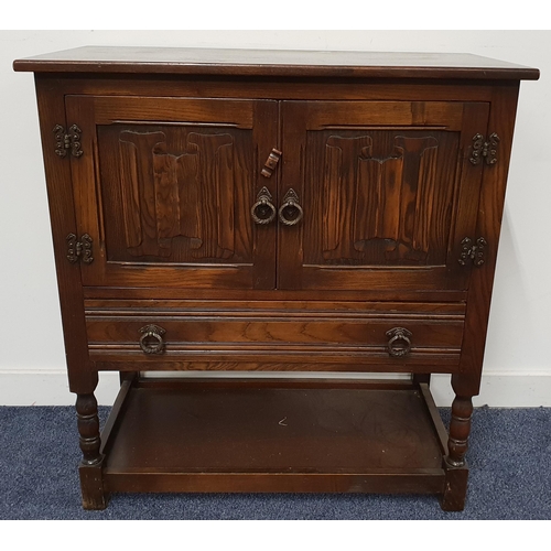 498 - OAK SIDE CABINET
with a moulded top above a pair of linen fold doors with a drawer below, standing o... 