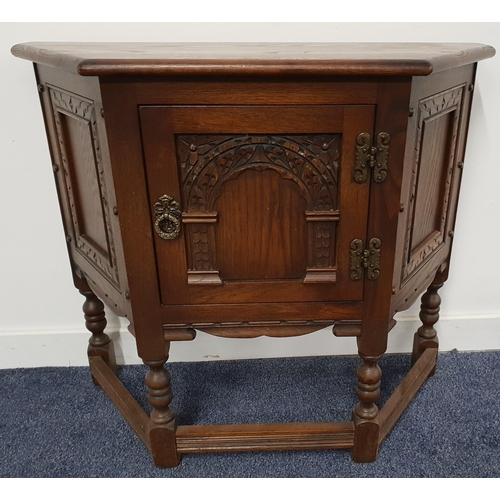 500 - OAK CREDENCE STYLE TABLE
with a moulded shaped top above a carved door flanked by moulded panels, st... 