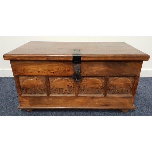 501 - TEAK BLANKET BOX
with a lift up lid and carved front panel, with side carry handles, standing on fla... 