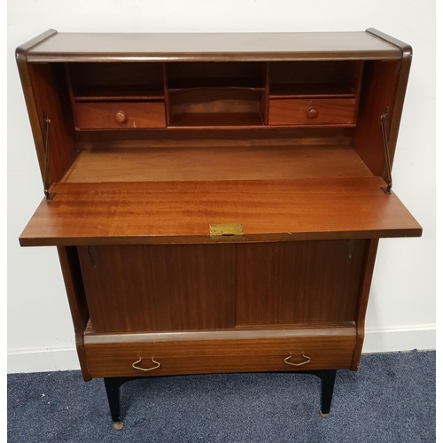 509 - 1950s TEAK SIDE CABINET
with a fall flap opening to reveal a fitted interior above a pair of sliding... 