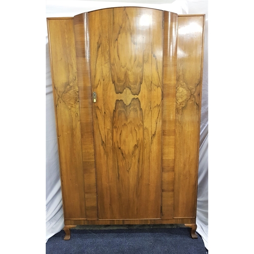 WARING & GILLOW WALNUT WARDROBE
with an arched central door opening to reveal hanging space, shelf and a mirror backed door, standing on stout cabriole supports, 192.5cm x 116.5cm