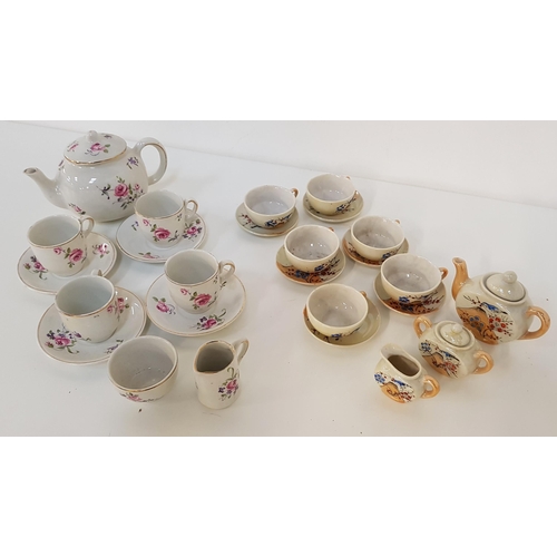 209 - CHILD'S POTTERY TEA SET
with a white ground and floral motifs, comprising four cups and saucers, mil... 