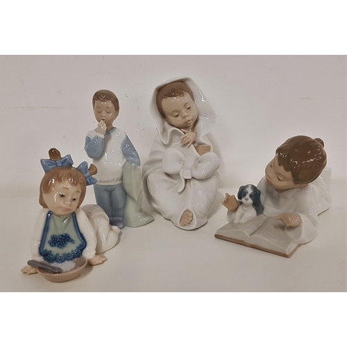 222 - FOUR NAO FIGURINES
including a boy with his puppy, reading a book, 18cm long, child wrapped in a bla... 