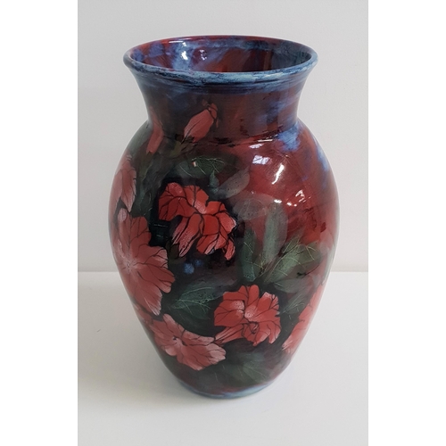 230 - HIGHLAND STONEWARE VASE
decorated with a blue ground and red flowers, 30.5cm high