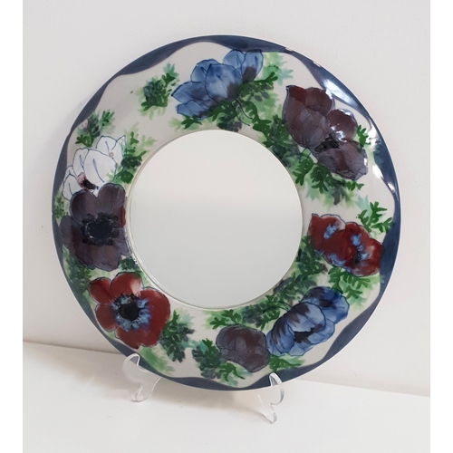 238 - HIGHLAND STONEWARE WALL MIRROR
in a circular frame decorated with poppies, 34.5cm diameter