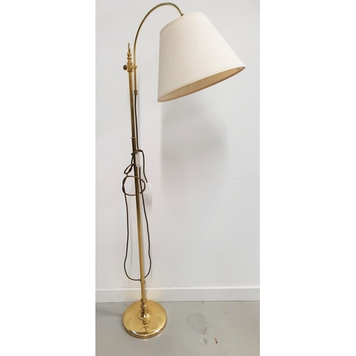 494 - BRASS STANDARD LAMP
raised on a circular base with a turned column and a shaped and height adjustabl... 