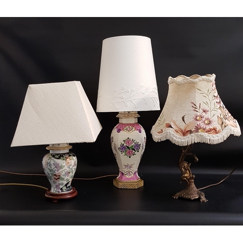 311 - THREE TABLE LAMPS
one raised on an hexagonal base with a porcelain body decorated with flowers, with... 