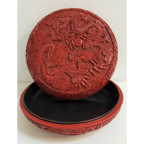 317 - EARLY 20th CENTURY CHINESE CINNABAR BOWL
and cover, profusely decorated with two five clawed   drago... 