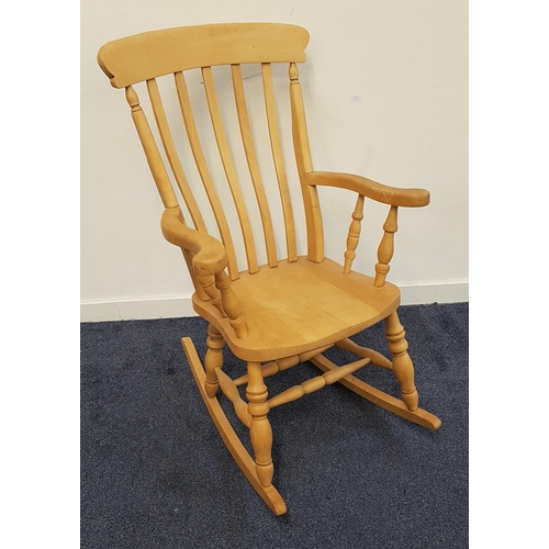 491 - BEECH ROCKING CHAIR
with a slatted back and shaped arms, on turned supports and shaped rockers