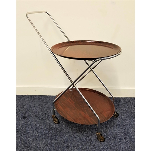 560 - RETRO WEST GERMAN DRINKS TROLLEY
with a chrome frame and wood effect laminated plastic removeable ci... 