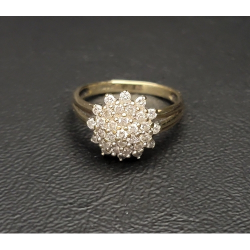 62 - IMPRESSIVE DIAMOND CLUSTER RING 
the graduated levels comprising thirty-one diamonds totalling appro... 