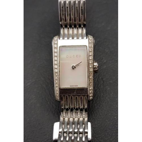 93 - LADIES GUCCI WATCH 
the rectangular mother-of-pearl dial flanked by clear gemstones, in stainless st... 