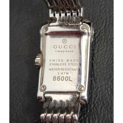 93 - LADIES GUCCI WATCH 
the rectangular mother-of-pearl dial flanked by clear gemstones, in stainless st... 