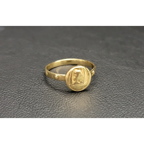 121 - FOURTEEN CARAT GOLD RING 
the textured disk on an embossed shank, approximately 2.5 grams and ring s... 