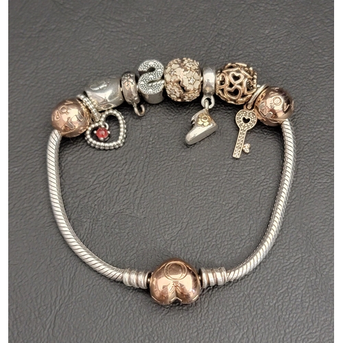 126 - PANDORA MOMENTS HEART CLASP SNAKE CHAIN BRACELET
with charms including a July Birthstone Heart Dangl... 