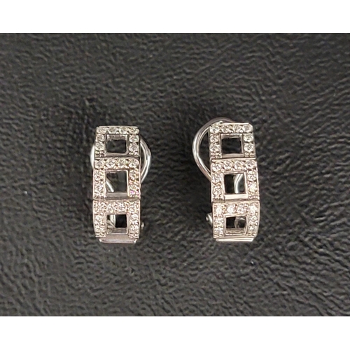 131 - PAIR OF DIAMOND CLUSTER EARRINGS
the diamonds set around the three pierced square settings, in nine ... 