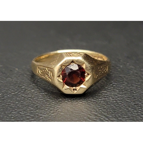 120 - GARNET SET SINGLE STONE RING
on nine carat gold shank with engraved scroll decoration to the shoulde... 