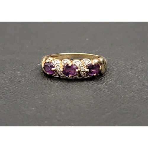 102 - AMETHYST AND DIAMOND DRESS RING
the three oval cut amethysts separated by small illusion set diamond... 