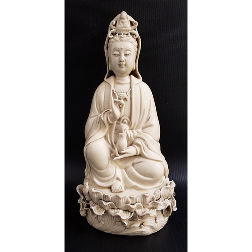 264 - CHINESE BLANC DE CHINE GUANYIN
holding a pearl in her raised right hand and a beaker in her left, se... 