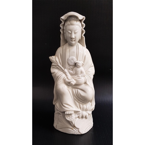 270 - BLANC DE CHINE FIGURE OF GUANYIN
seated with a child on her lap, 19.5cm high