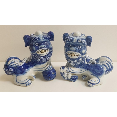 273 - PAIR OF CHINESE BLUE AND WHITE DOGS OF FO
each with a raised paw, 21cm high (2)