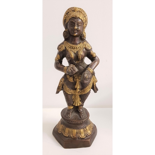 328 - BRONZE HINDU DEITY
of a female standing on a shaped base, 29cm high